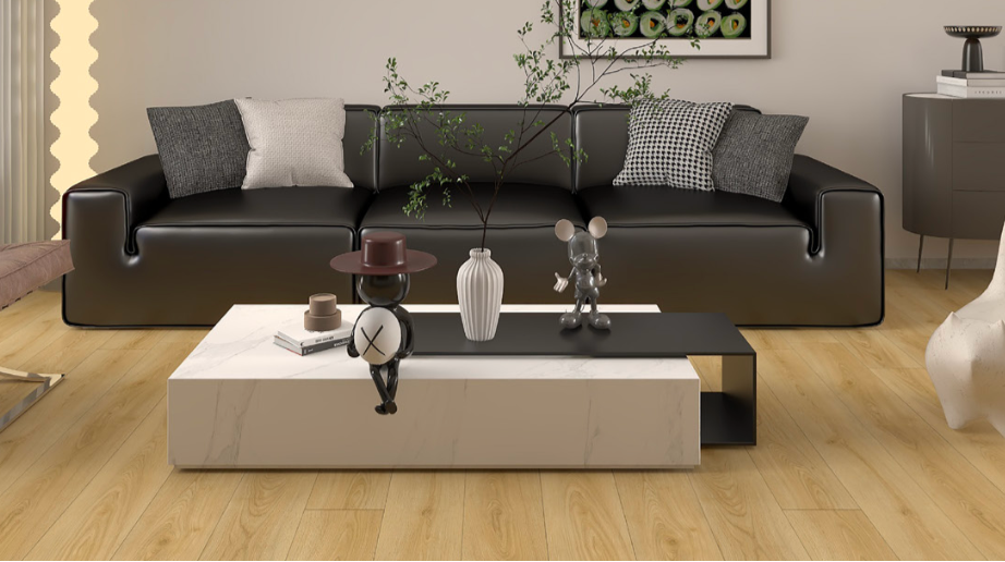 Modern living room with black sofa, coffee table, and decorative items.