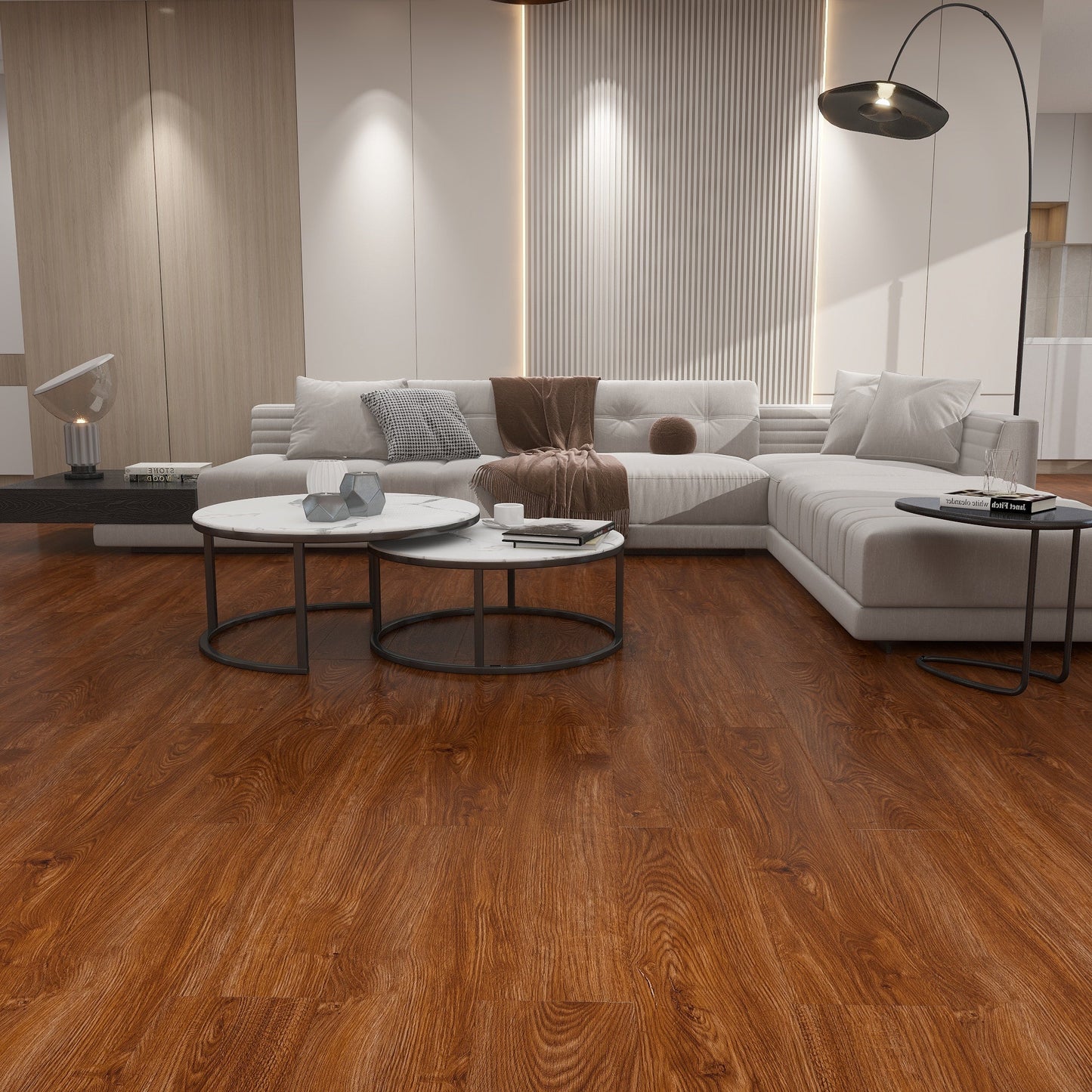 Modern living room with wooden flooring, white sofa, and decorative items.