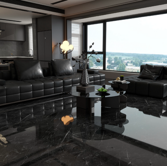 Modern black leather sofa in a stylish living room with large windows.