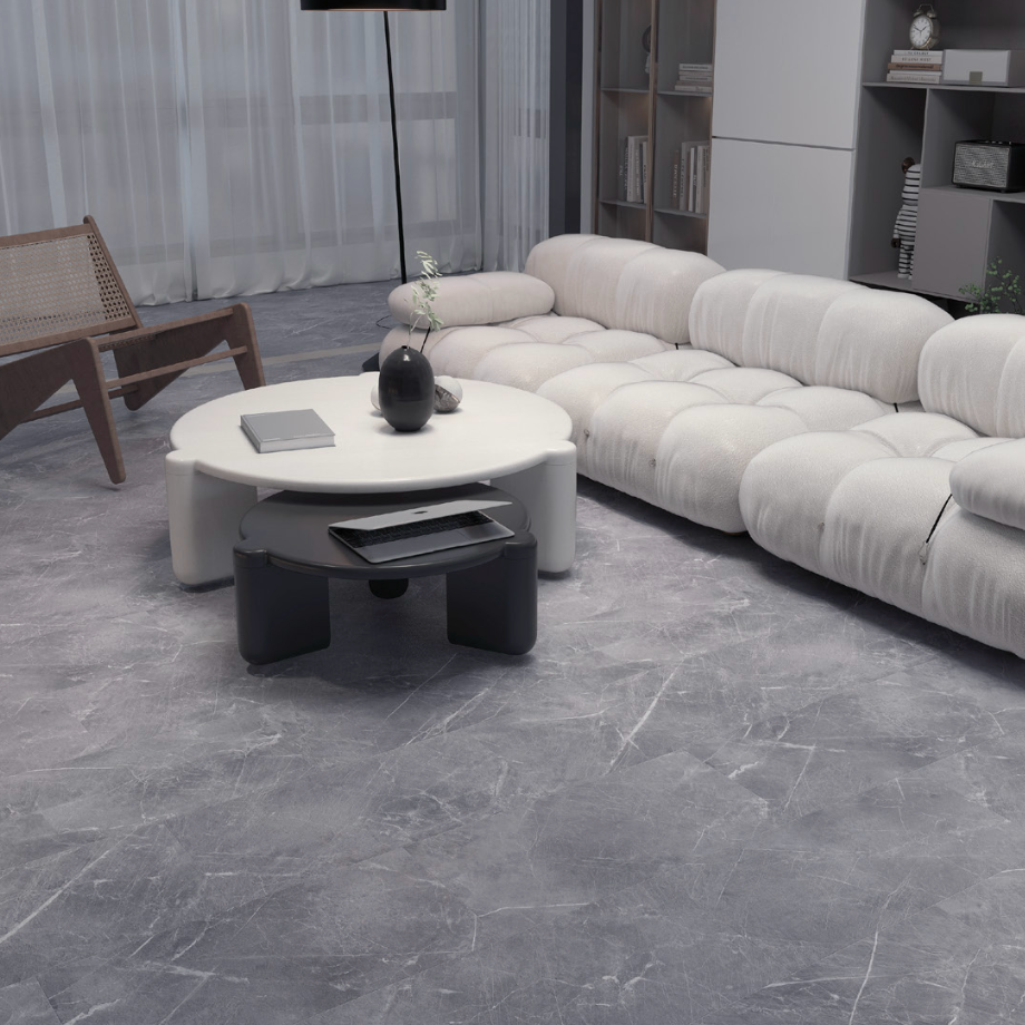 Modern living room with a white sectional sofa, round coffee table, and decorative items.