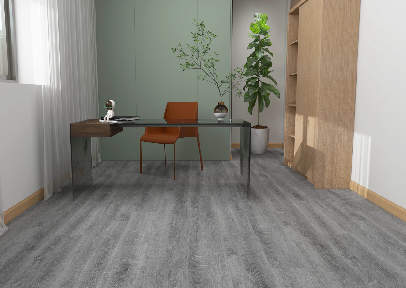 Modern office interior with a desk, chair, and plants on a gray wooden floor.